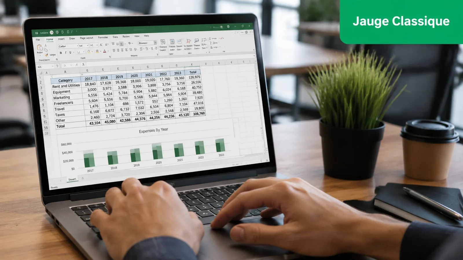 Une personne utilisant un ordinateur portable affichant un tableau de dépenses et un graphique dans Excel.